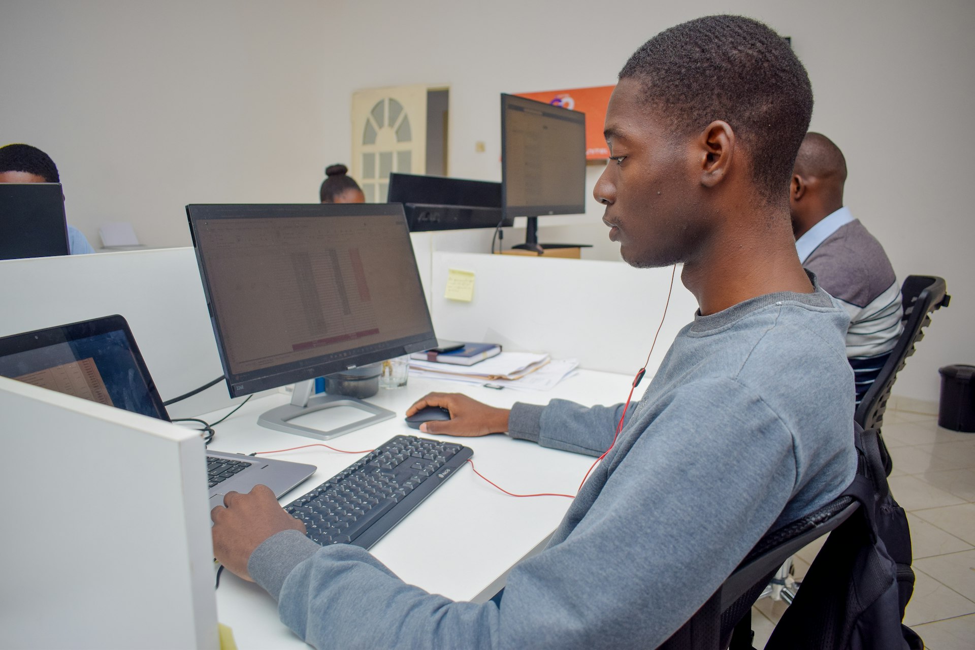 A man sitting at a desk using a computer